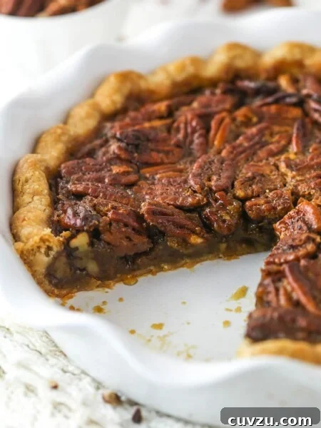 Classic Lemon Meringue Pie Recipe with Flaky Crust and Zesty Filling 7 Classic Pecan Pie in a white baking pan with a slice removed.