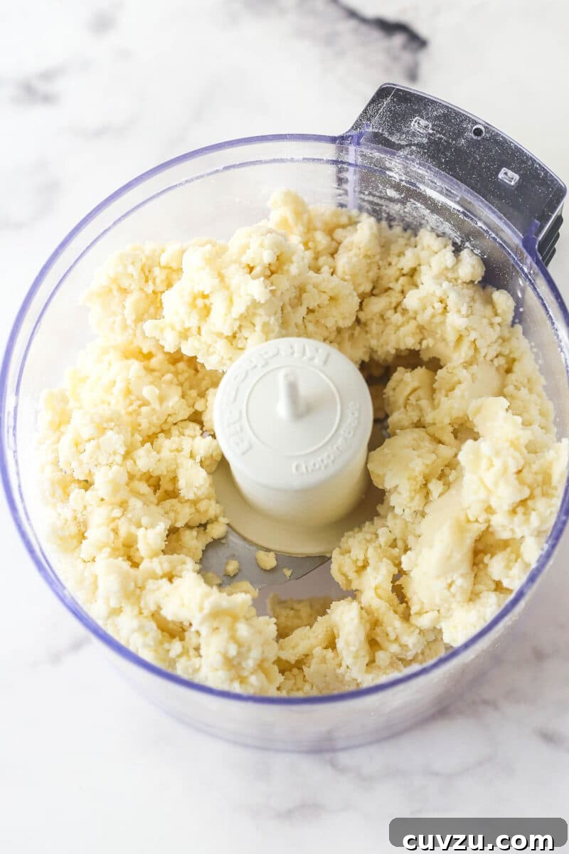 This classic lemon meringue pie features a tart lemon filling in a buttery crust topped with a light but stable meringue. Butter and flour in a food processor