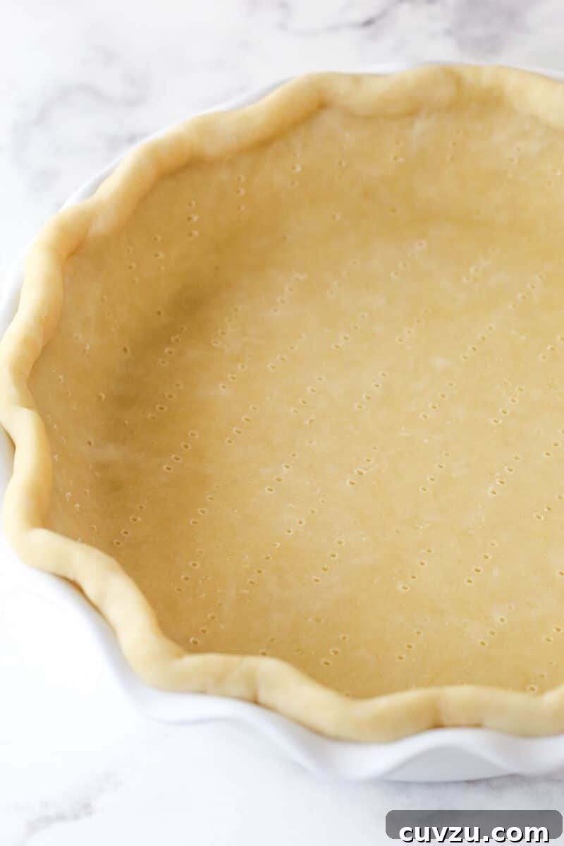 This classic lemon meringue pie features a tart lemon filling in a buttery crust topped with a light but stable meringue. Pie crust dough in a pie pan