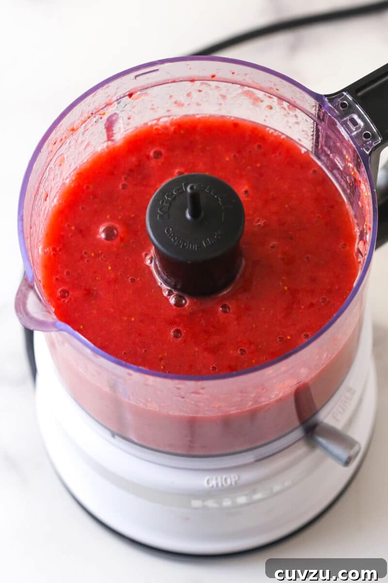 Pureed fresh strawberries in a mixing bowl
