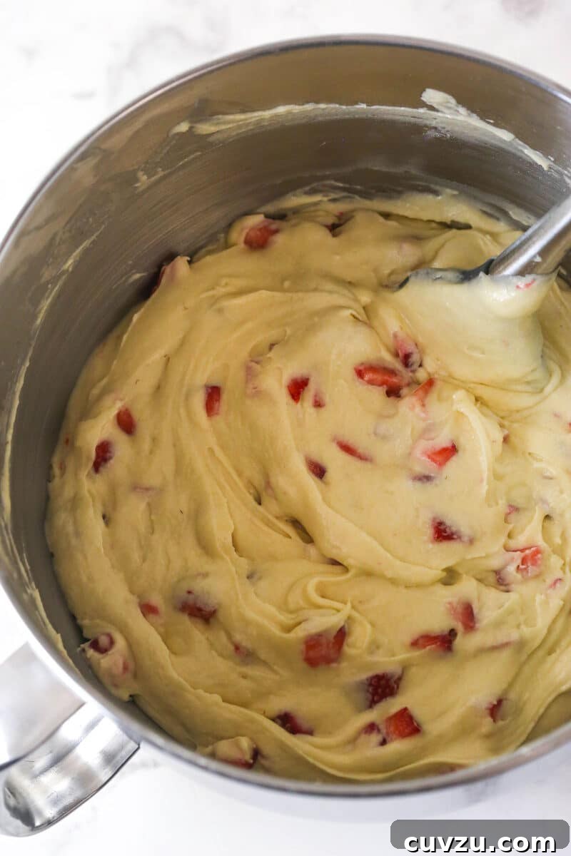 Diced strawberries folded into cake batter