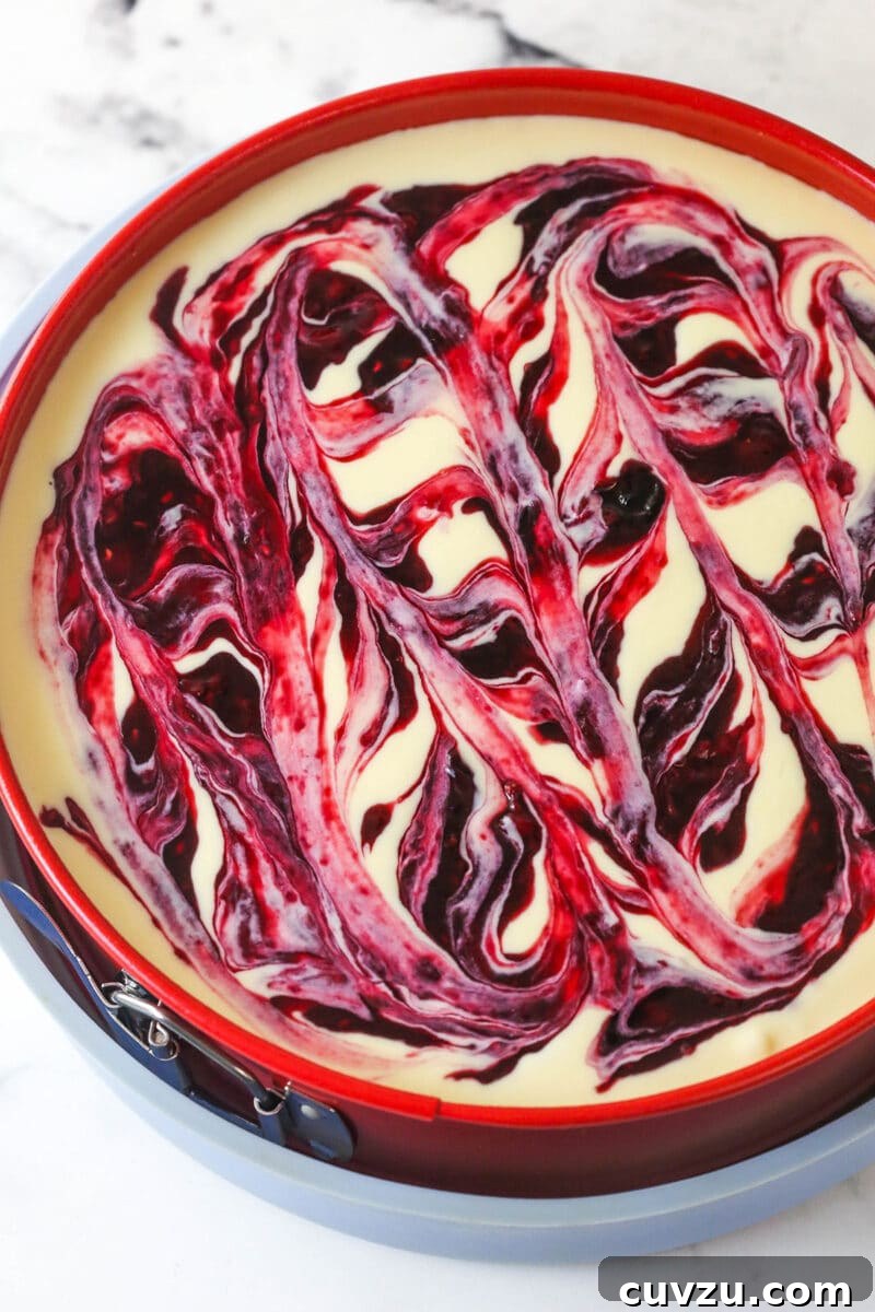 Triple Berry Cheesecake Recipe with Fresh Mixed Berries 15 unbaked cheesecake with berry swirl on top
