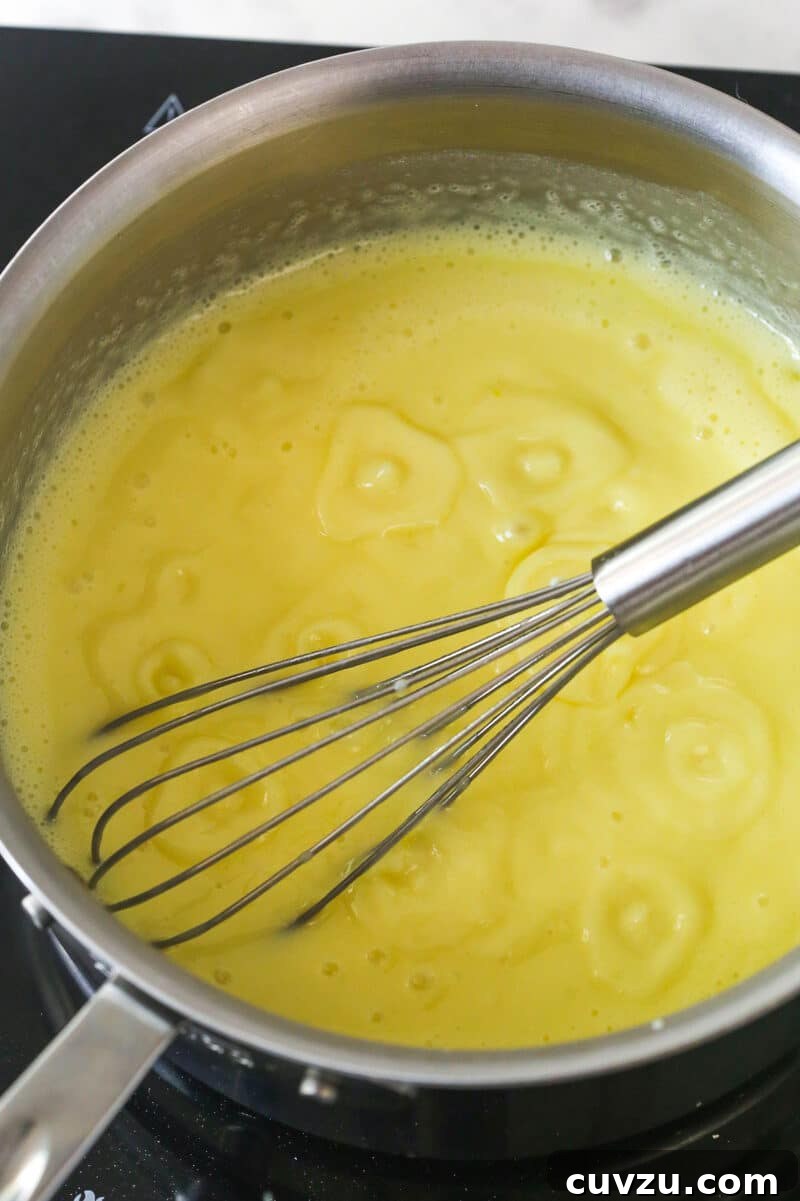 Magnolia Bakery-Style Banana Pudding Recipe from Scratch 6 Whisking pudding on stovetop