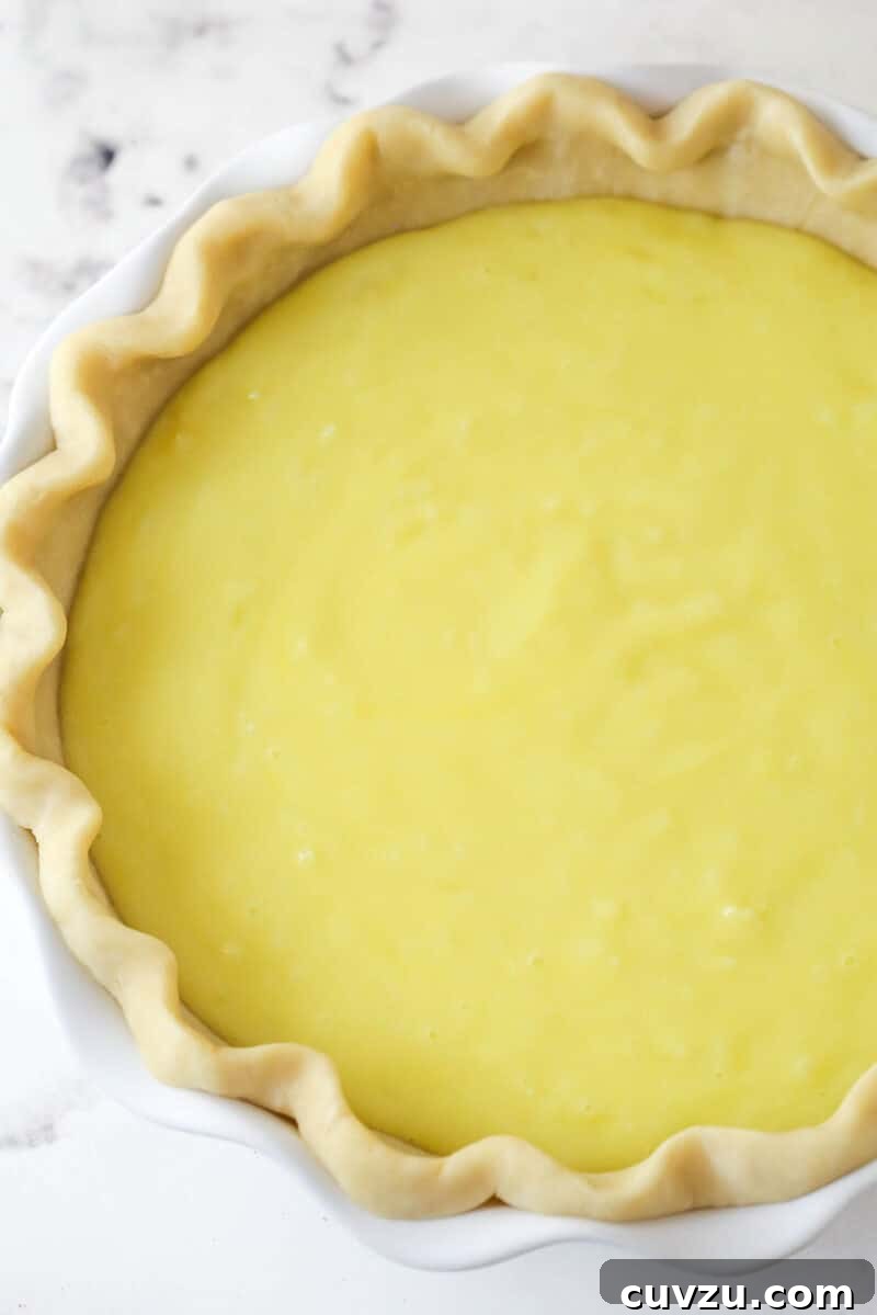 Pour filling into chilled crust. Overhead view of an unbaked coconut custard pie