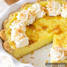A coconut custard pie with a slice missing