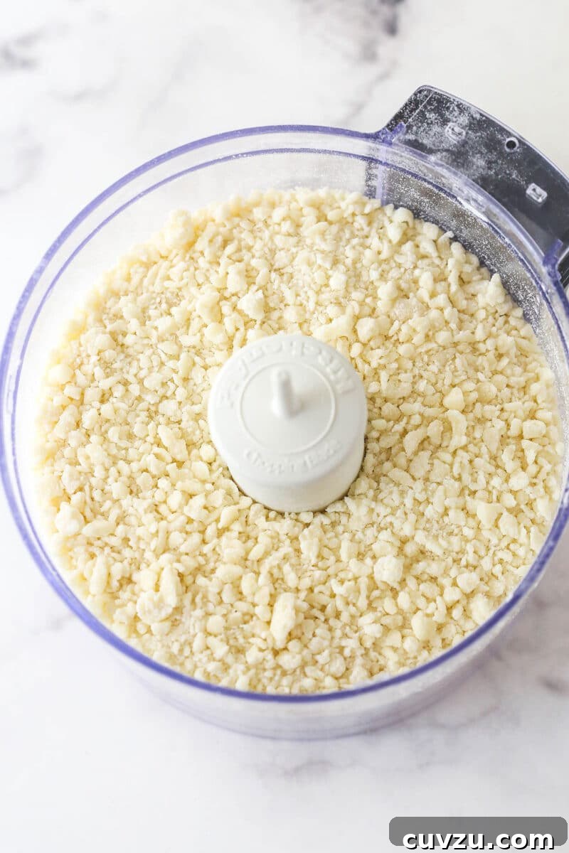Sandy dough before adding water. Butter and flour pulsed into sand-like crumbs